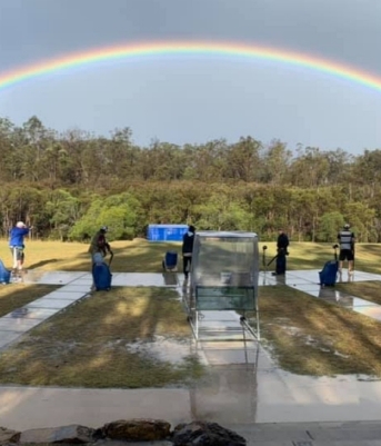 Experience the beauty of a rainbow as it arches over a field, with people peacefully gathered beneath. Book your private tour today for an unforgettable adventure.